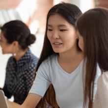 Two students sitting at a laptop together